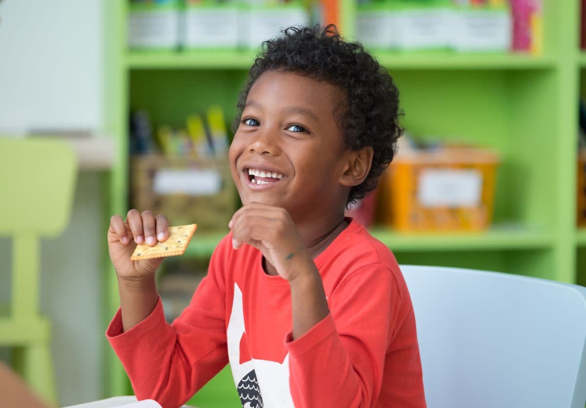 Happy child eating nutritious food